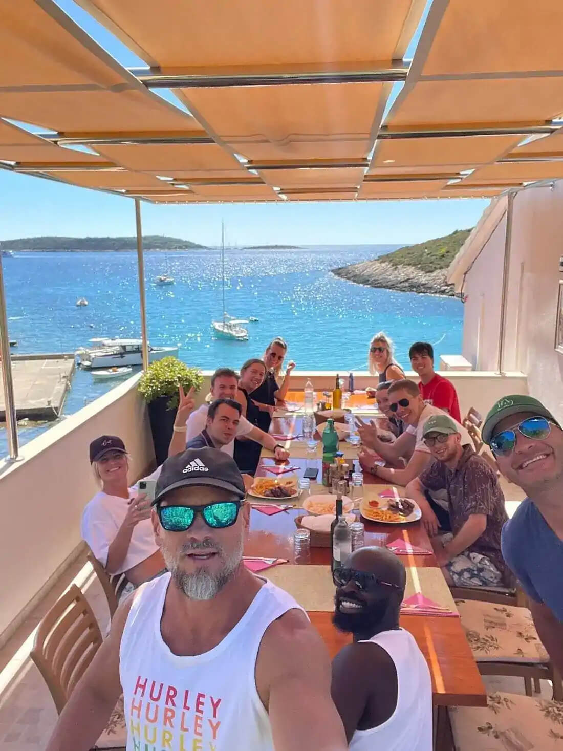 Guests enjoying an all-inclusive lunch in a private summerhouse on the Blue Cave tour from Split